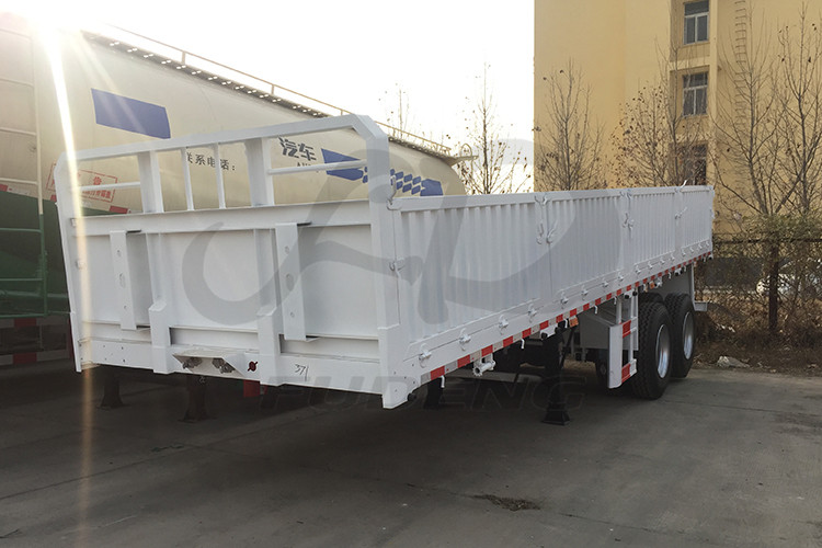 Product Description FUDENG 2 axles 20ft sidewall container semi trailers the sidewall height is 800mm can satisfy mostly customers loose cargo haulage demands. The customer need to do short distance haulage and the road condition very bad, instead of choose 40ft lnegth sidewall semi trailers the customer need shorter trailers to transport. The road has many curve turns which need the trailer easy to make a turn.