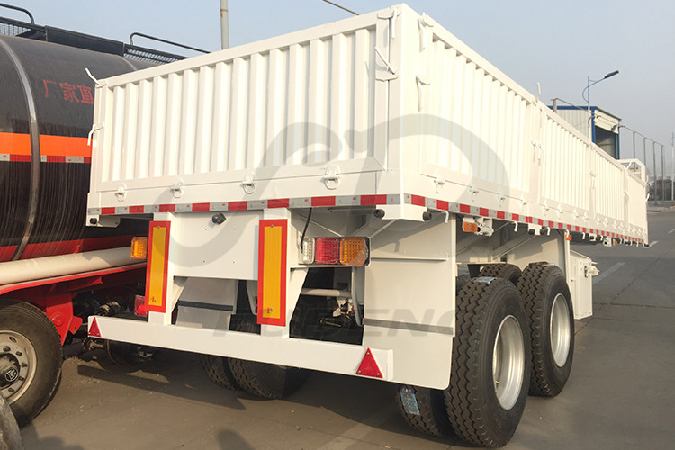 Product Description FUDENG 2 axles 20ft sidewall container semi trailers the sidewall height is 800mm can satisfy mostly customers loose cargo haulage demands. The customer need to do short distance haulage and the road condition very bad, instead of choose 40ft lnegth sidewall semi trailers the customer need shorter trailers to transport. The road has many curve turns which need the trailer easy to make a turn.